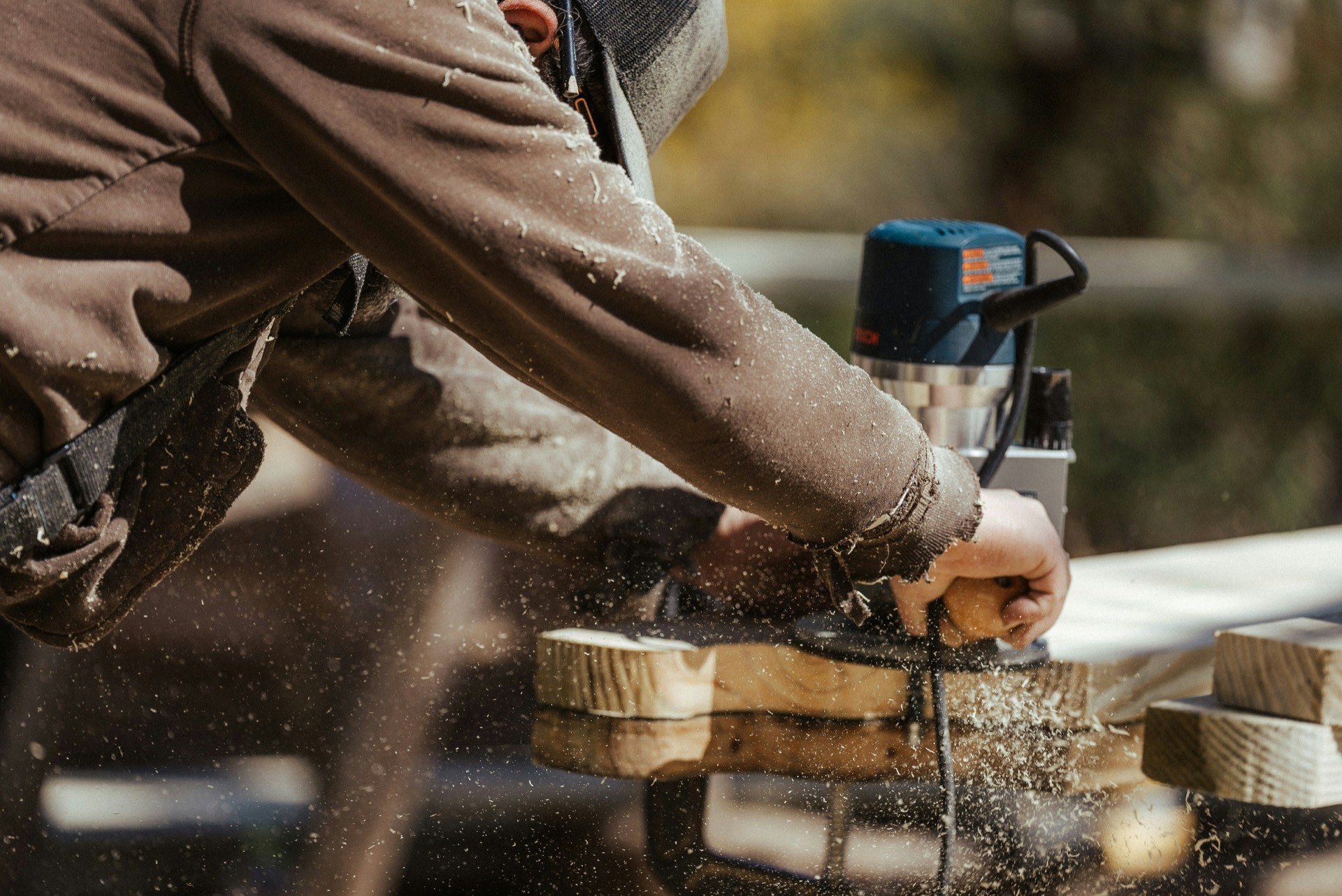 Sonoma Custom Saunas carpenter cutting cedar boards for a new bench