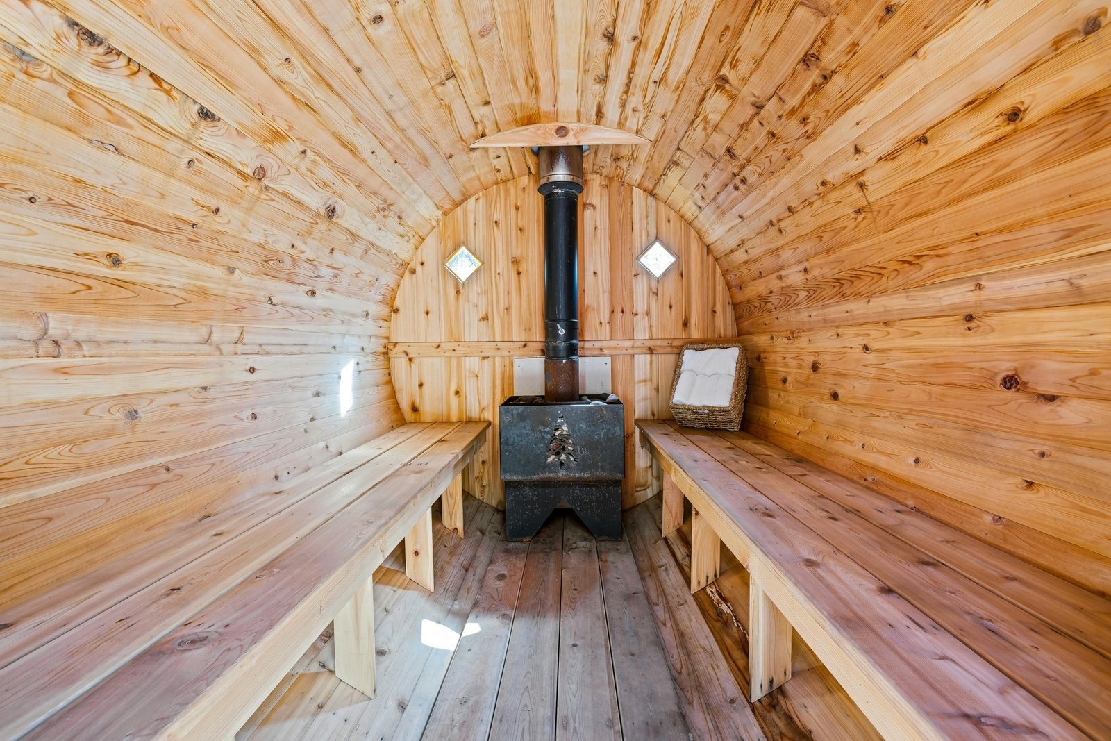 Barrel sauna interior with a wood-fired stove, built for a Sonoma ranch